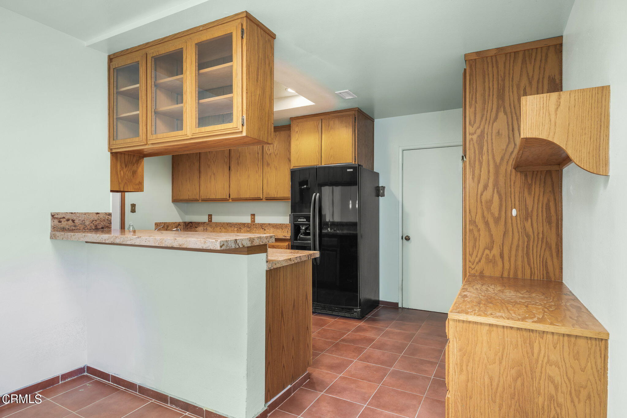 3131 Armada Drive Ventura, CA 93003 - Photo 11 of 31 a kitchen with granite countertop a refrigerator and a stove