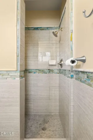 a bathroom with a granite countertop shower and a sink