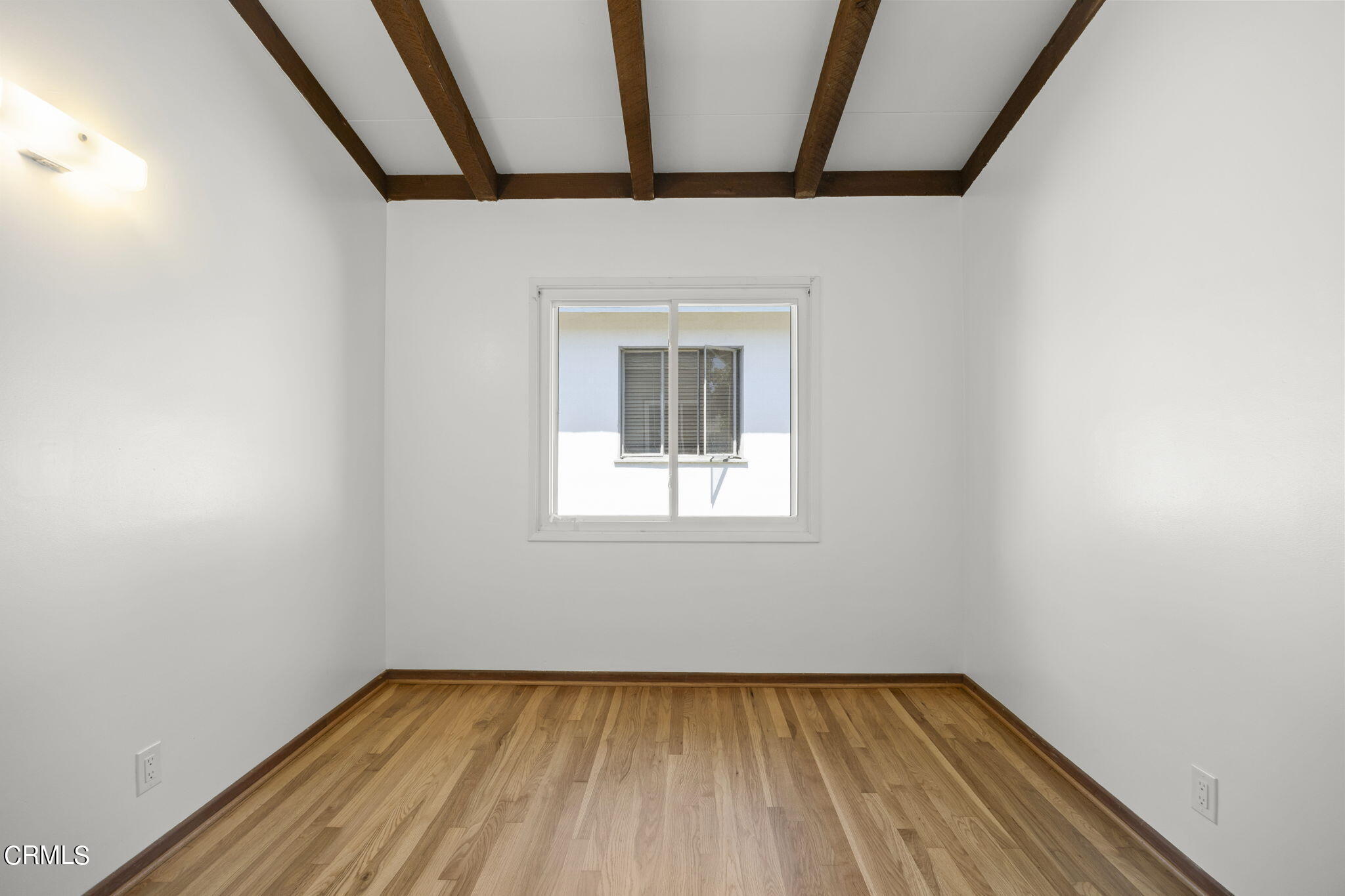 3131 Armada Drive Ventura, CA 93003 - Photo 19 of 31 a view of an empty room with wooden floor and a window