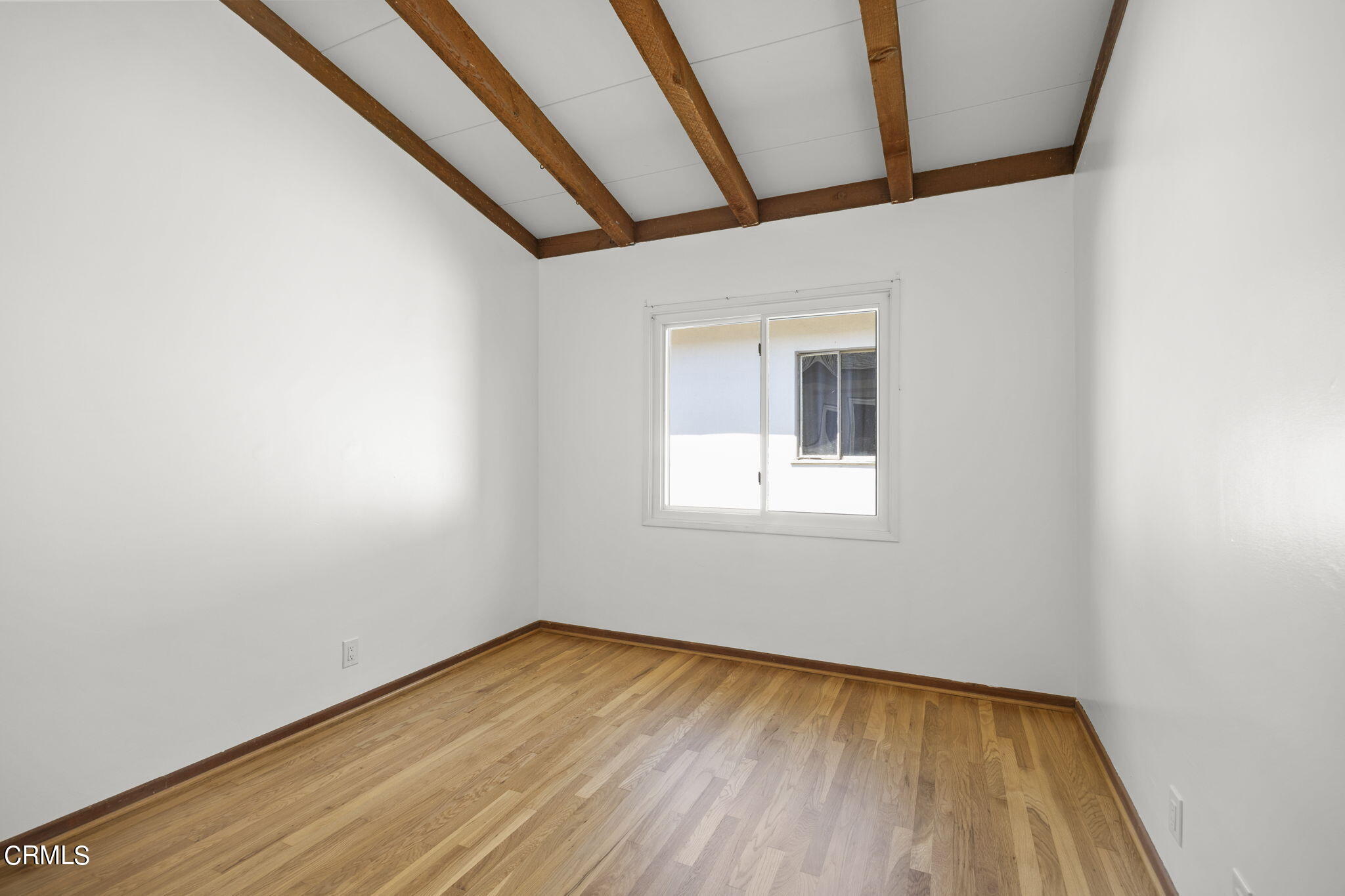 3131 Armada Drive Ventura, CA 93003 - Photo 20 of 31 a view of an empty room with wooden floor and a window