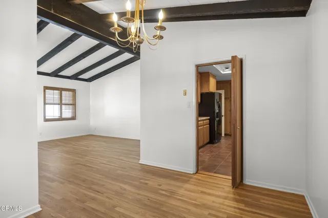 a view of hallway with wooden floor and stairs