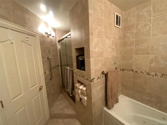 a bathroom with a bathtub and a shower