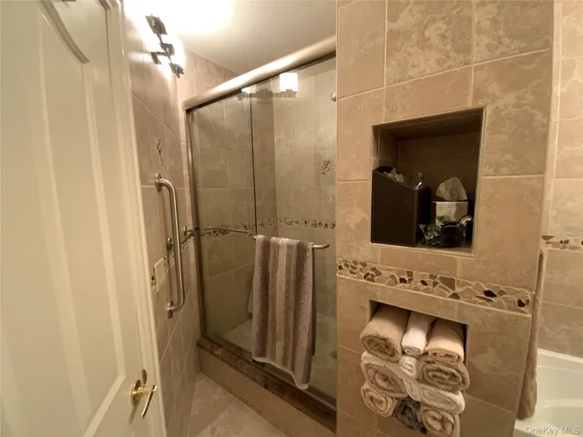 a bathroom with a mirror and a shower