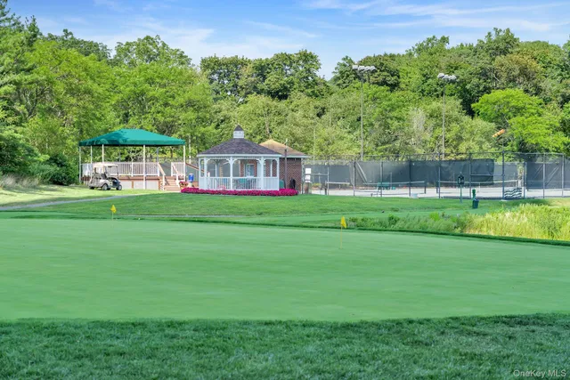 a view of a house with a yard and sitting area