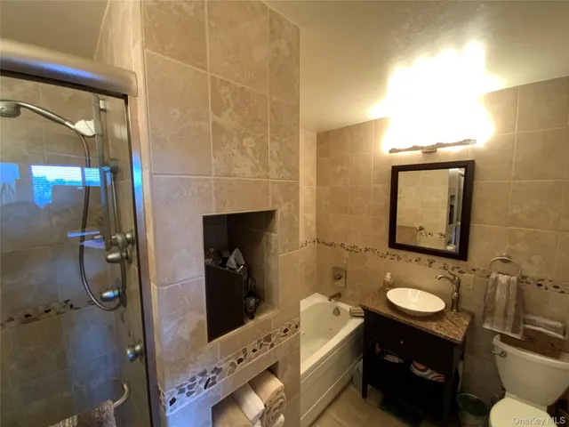 a bathroom with a sink mirror vanity and toilet