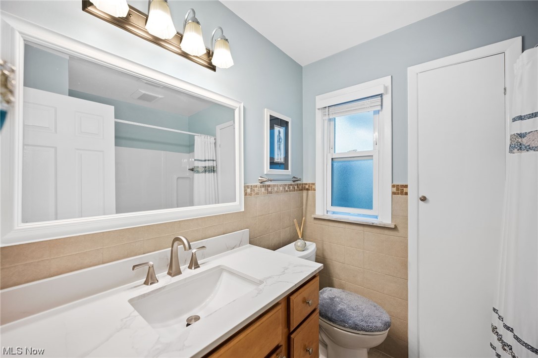 1970 Som Center Road Cleveland, OH 44124 - Photo 25 of 35 Bathroom featuring tile walls, vanity, and toilet