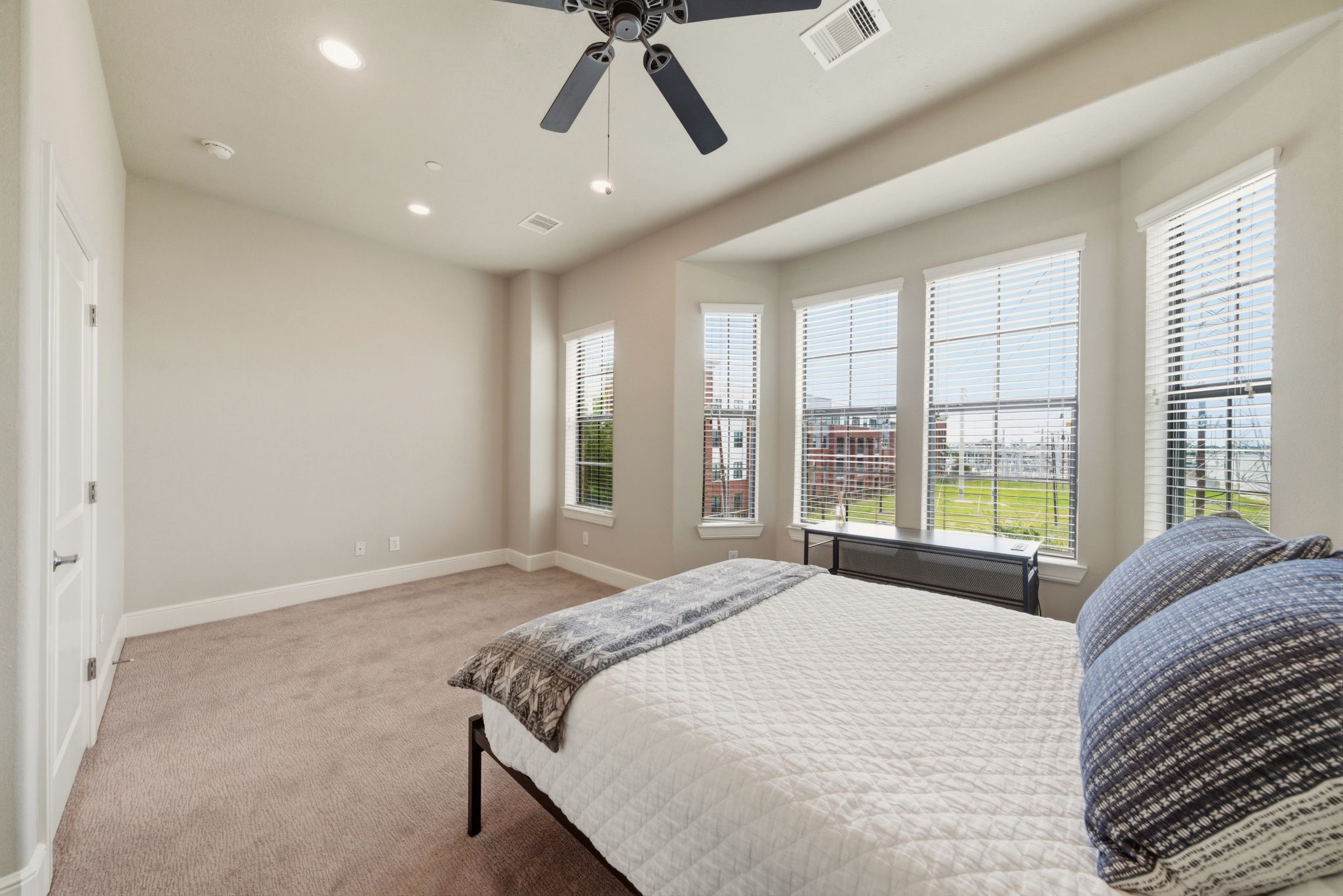 2110 Shearn Street, Unit 16 Houston, TX 77007 - Photo 14 of 37 Primary bedroom - again, lots of WINDOWS = lots of NATURAL LIGHT! Neutral colored carpet installed in 2024