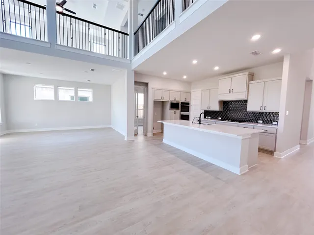a view of kitchen with stainless steel appliances sink refrigerator microwave and stove