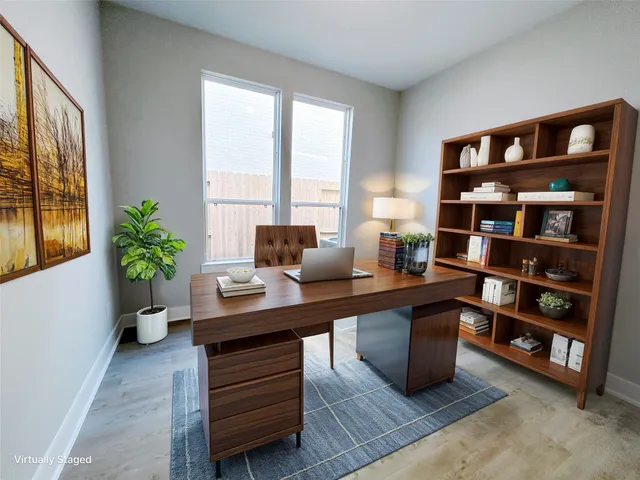 a view of a workspace with furniture and a potted plant