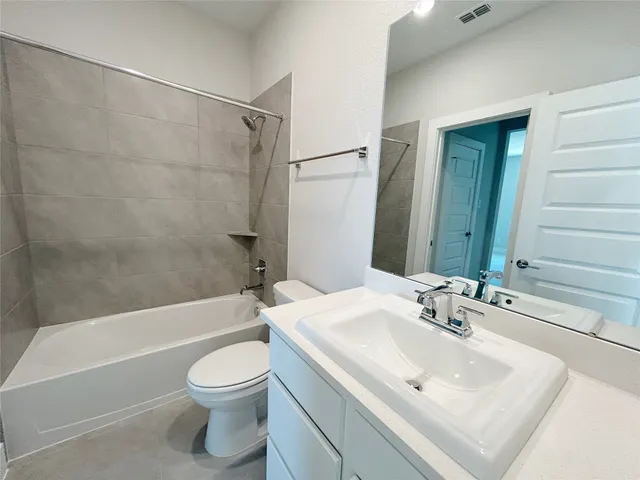 a white bath tub sitting next to a white toilet