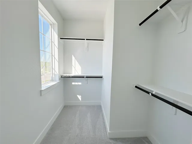 a bathroom with a window and a shower curtain