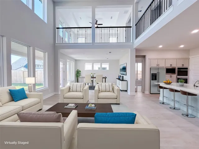 a living room with furniture wooden floor and a large window