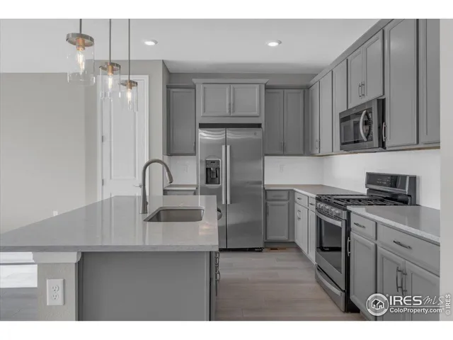 a bathroom with a granite countertop sink a toilet and a mirror