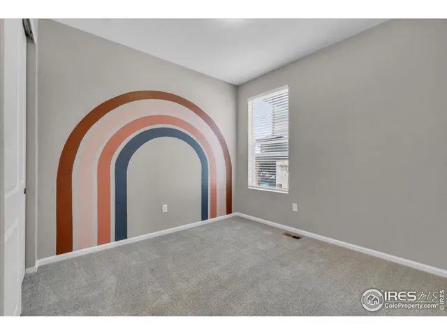 a view of a livingroom with a ceiling fan and window