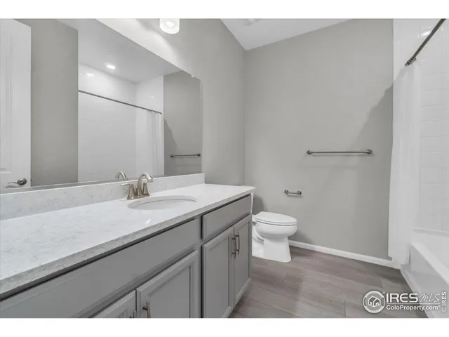a bathroom with a tub a sink and a mirror