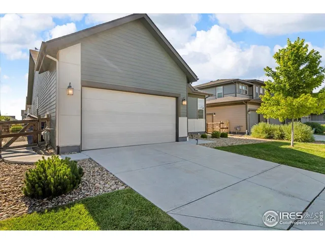 a green field with some trees in front of it