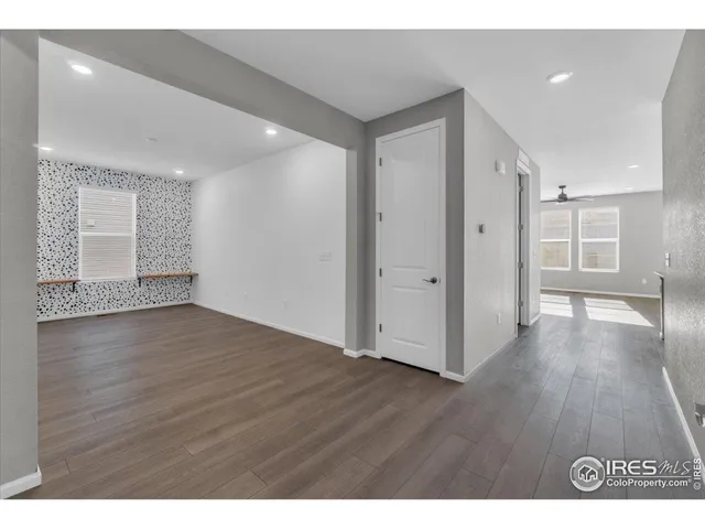 a kitchen with stainless steel appliances kitchen island a table and chairs in it