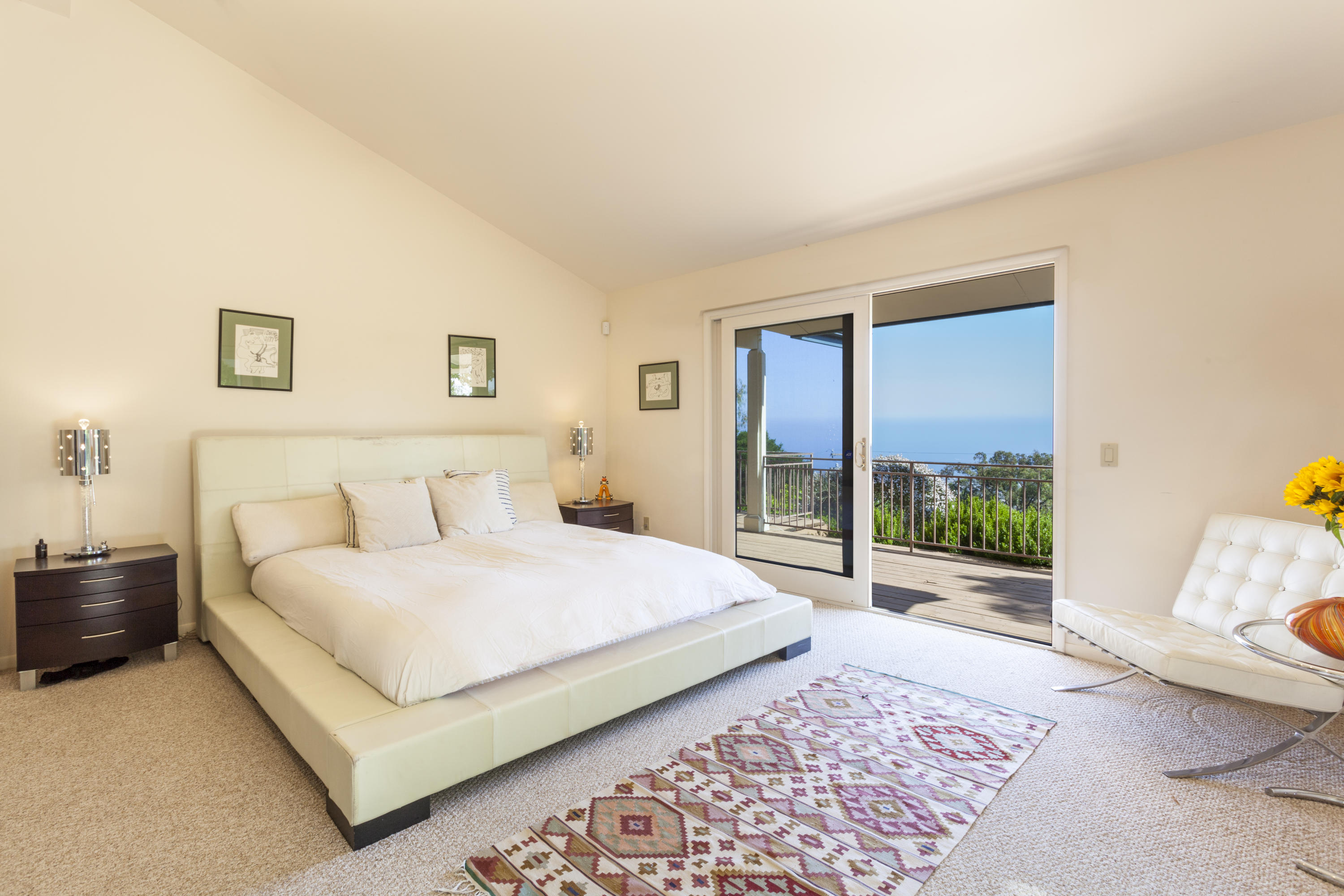 1568 Franceschi Road Santa Barbara, CA 93103 - Photo 6 of 16 a bedroom with a bed lamp and a large window