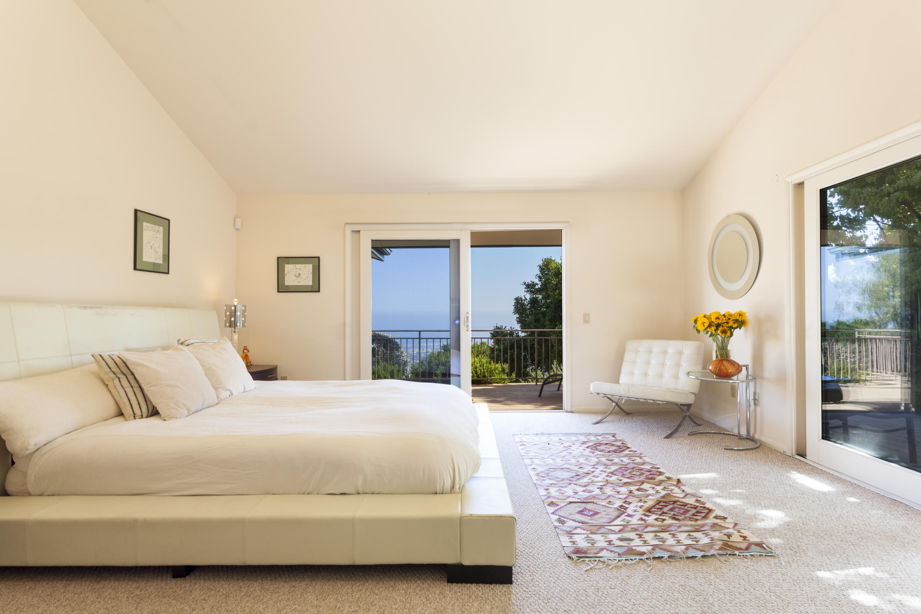 1568 Franceschi Road Santa Barbara, CA 93103 - Photo 7 of 16 a bedroom with a bed and glass door