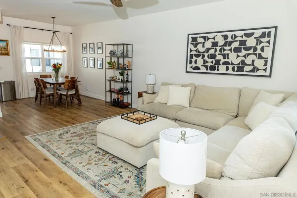 a living room with furniture and painting on the wall