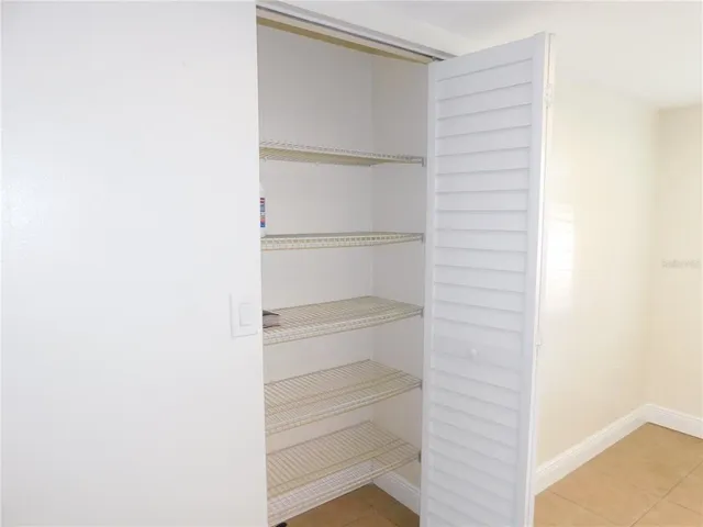 a view of walk in closet with empty racks
