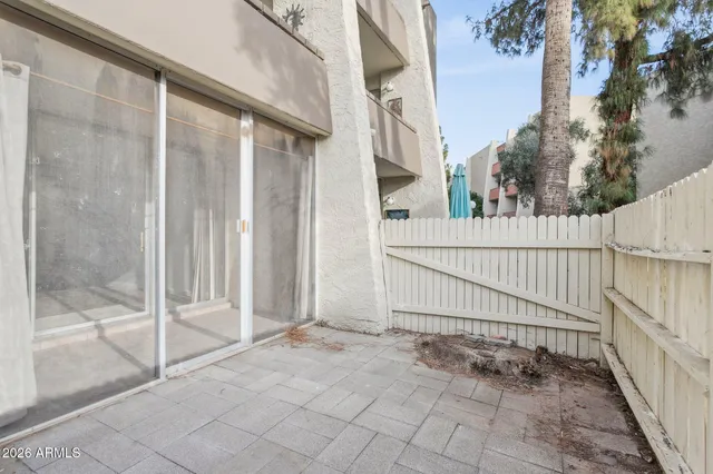 a view of a house with a wooden fence