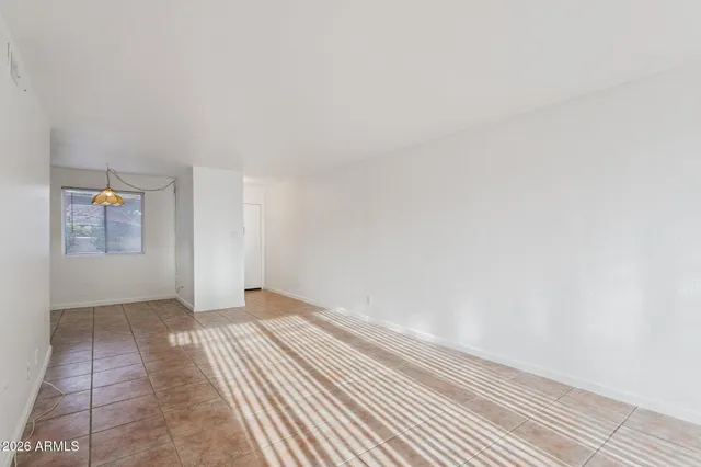 a view of an empty room and wooden floor