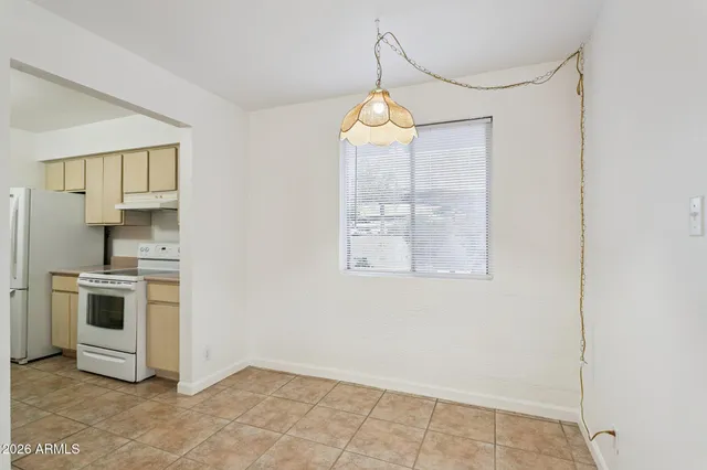 a kitchen with stainless steel appliances a stove a refrigerator and cabinets
