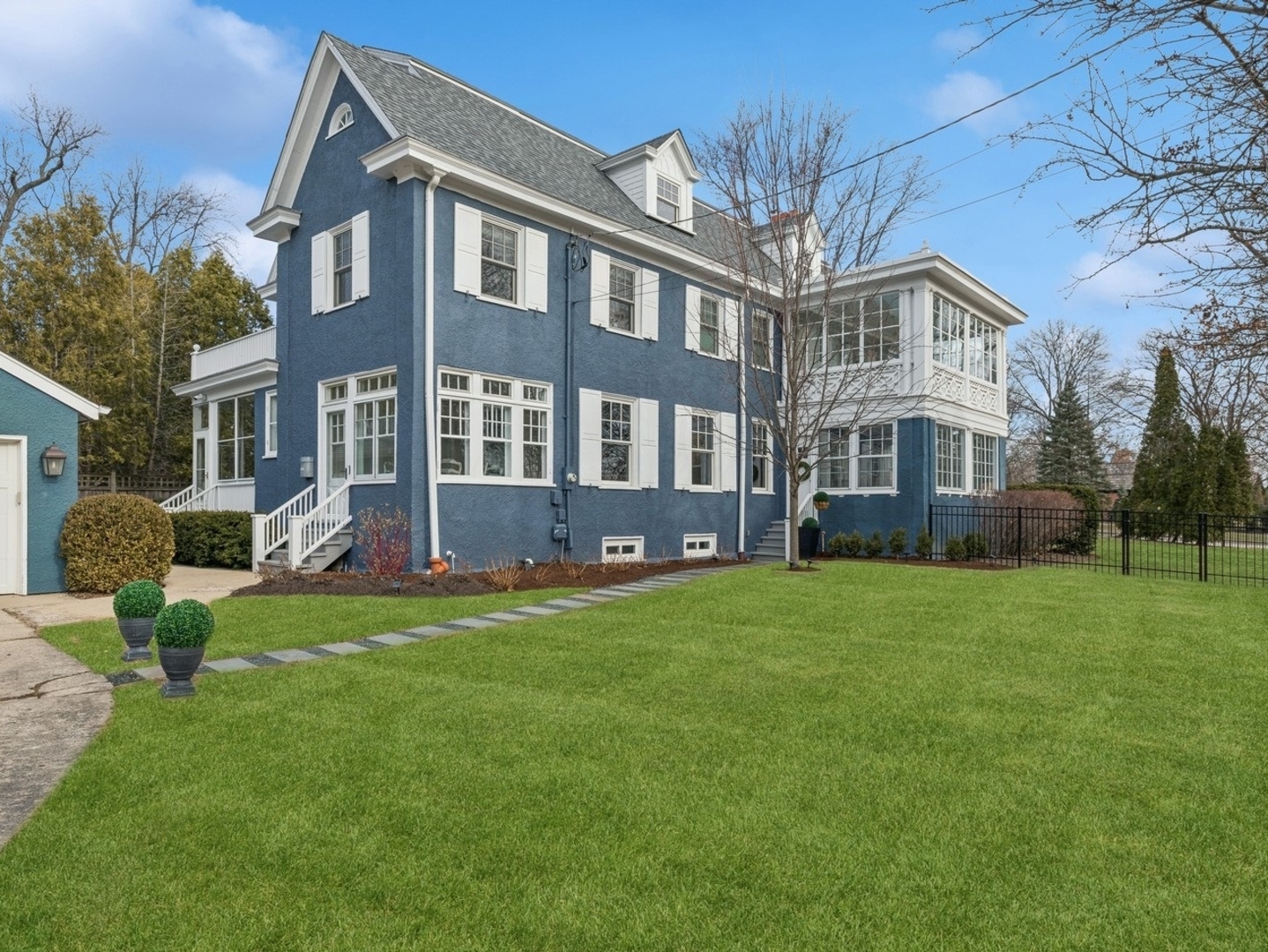 a front view of a house with a garden