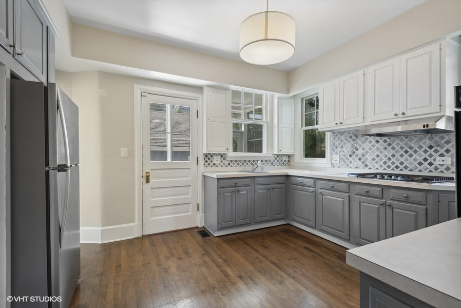 160 Sheridan Road Glencoe, IL 60093 - Photo 16 of 46 a kitchen with granite countertop a sink cabinets stainless steel appliances and a window
