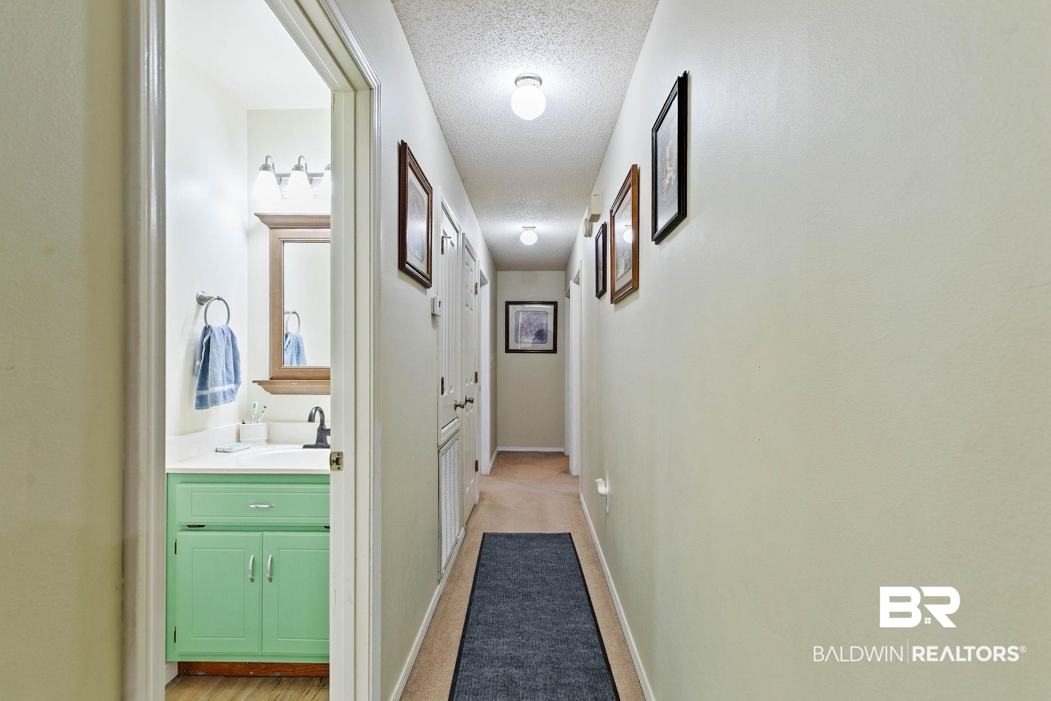 1510 South Juniper Street Foley, AL 36535 - Photo 17 of 36 Hall featuring a textured ceiling and light carpet
