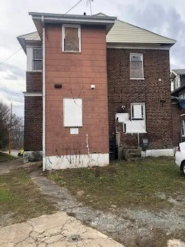 a brick house with a yard in front of it
