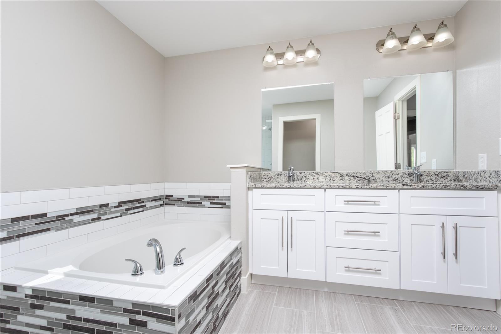 2505 Spring Hill Court Highlands Ranch, CO 80129 - Photo 17 of 40 a bathroom with a tub sink and mirror