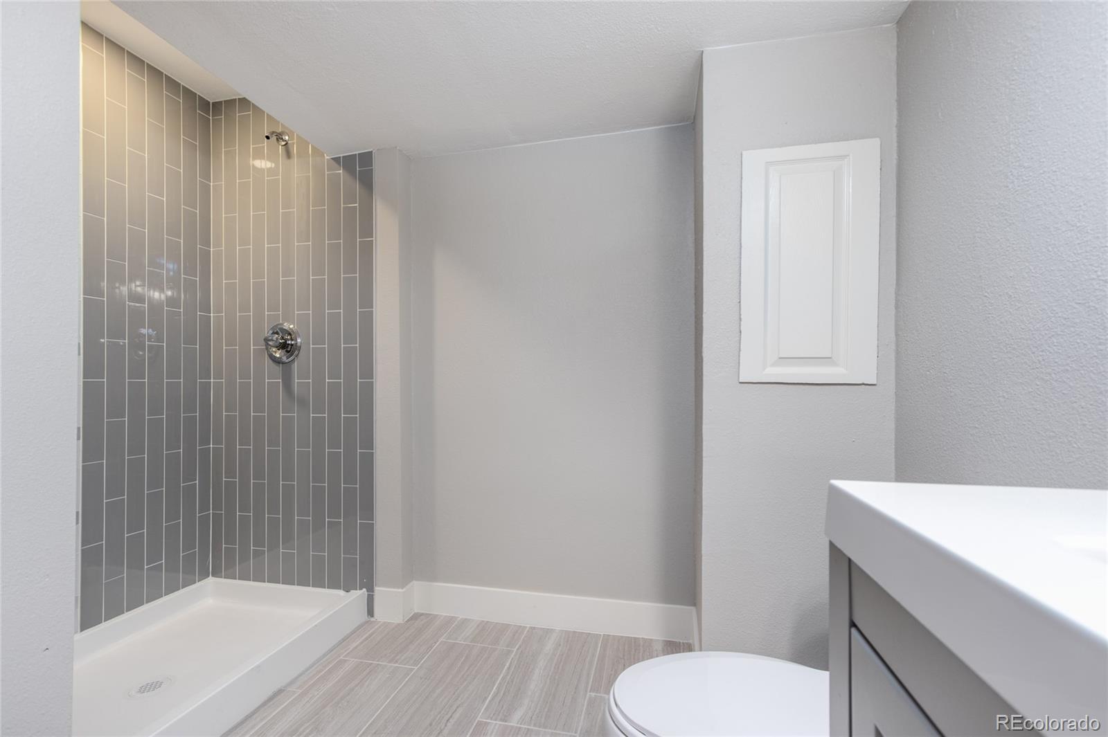 2505 Spring Hill Court Highlands Ranch, CO 80129 - Photo 20 of 40 a bathroom with a shower a toilet and sink