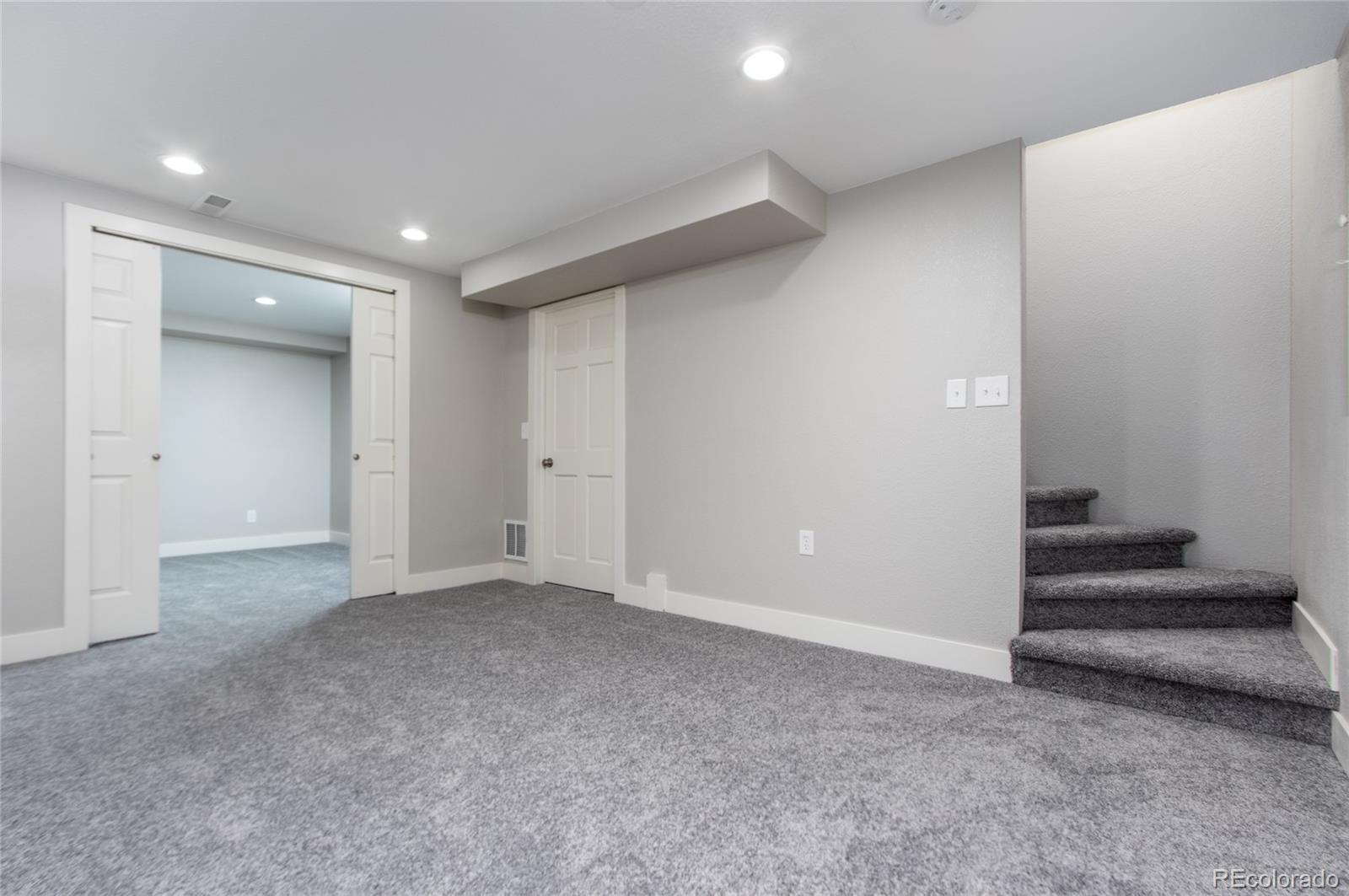 2505 Spring Hill Court Highlands Ranch, CO 80129 - Photo 28 of 40 a view of an empty room with stairs and ventilation