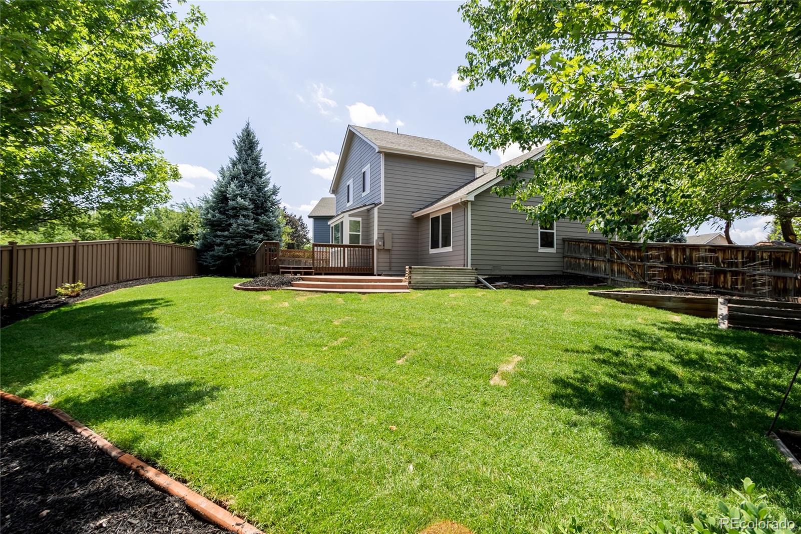 2505 Spring Hill Court Highlands Ranch, CO 80129 - Photo 31 of 40 a front view of house with yard and trees