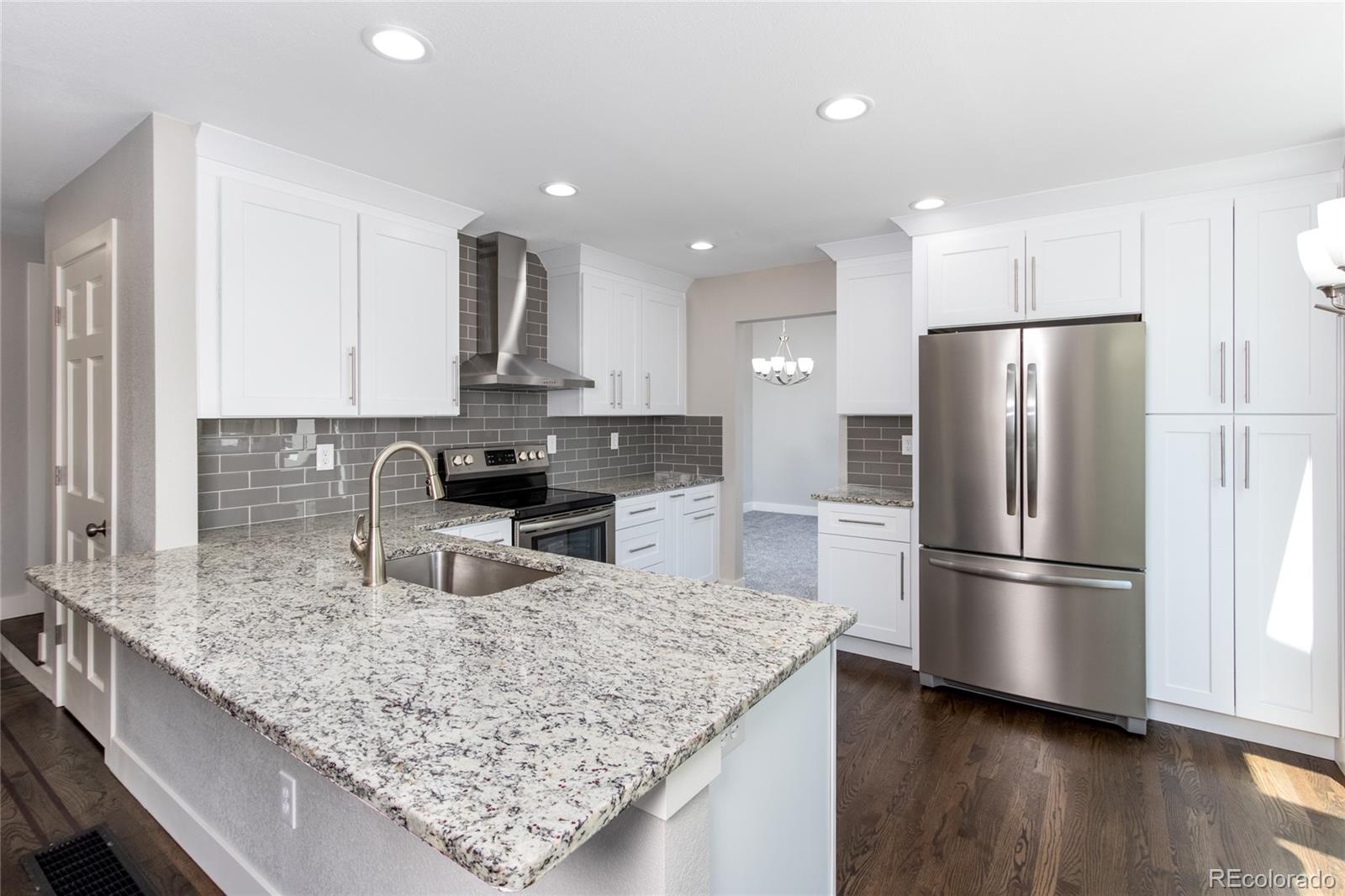 2505 Spring Hill Court Highlands Ranch, CO 80129 - Photo 5 of 40 a kitchen with stainless steel appliances granite countertop a refrigerator a stove a sink and a granite counter tops