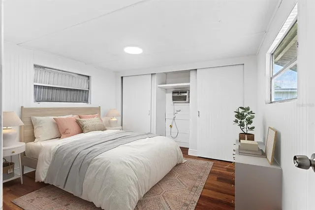 a bedroom with a large bed and a potted plant