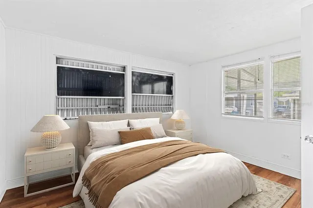 a bedroom with bed and flat screen tv
