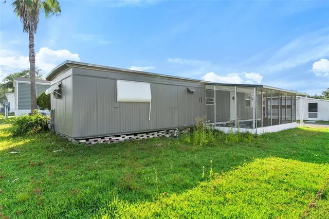 a view of an house with backyard space and garden