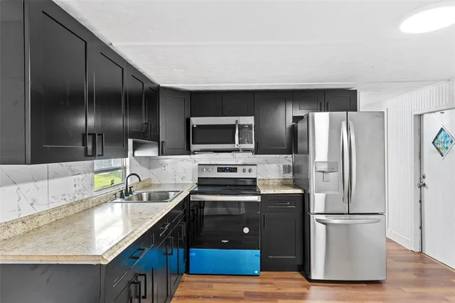 a kitchen with a refrigerator sink and stove
