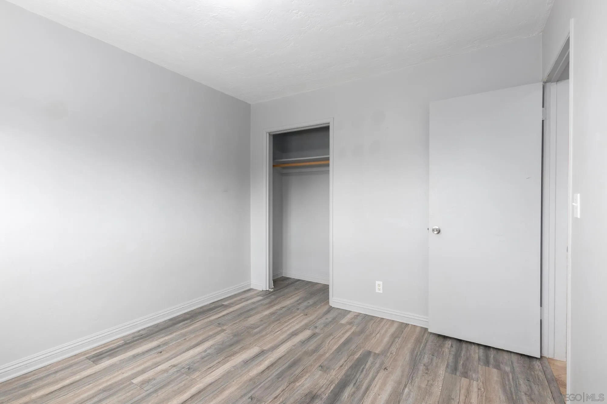 909 North Midway Drive Escondido, CA 92027 - Photo 11 of 19 a view of an empty room with wooden floor