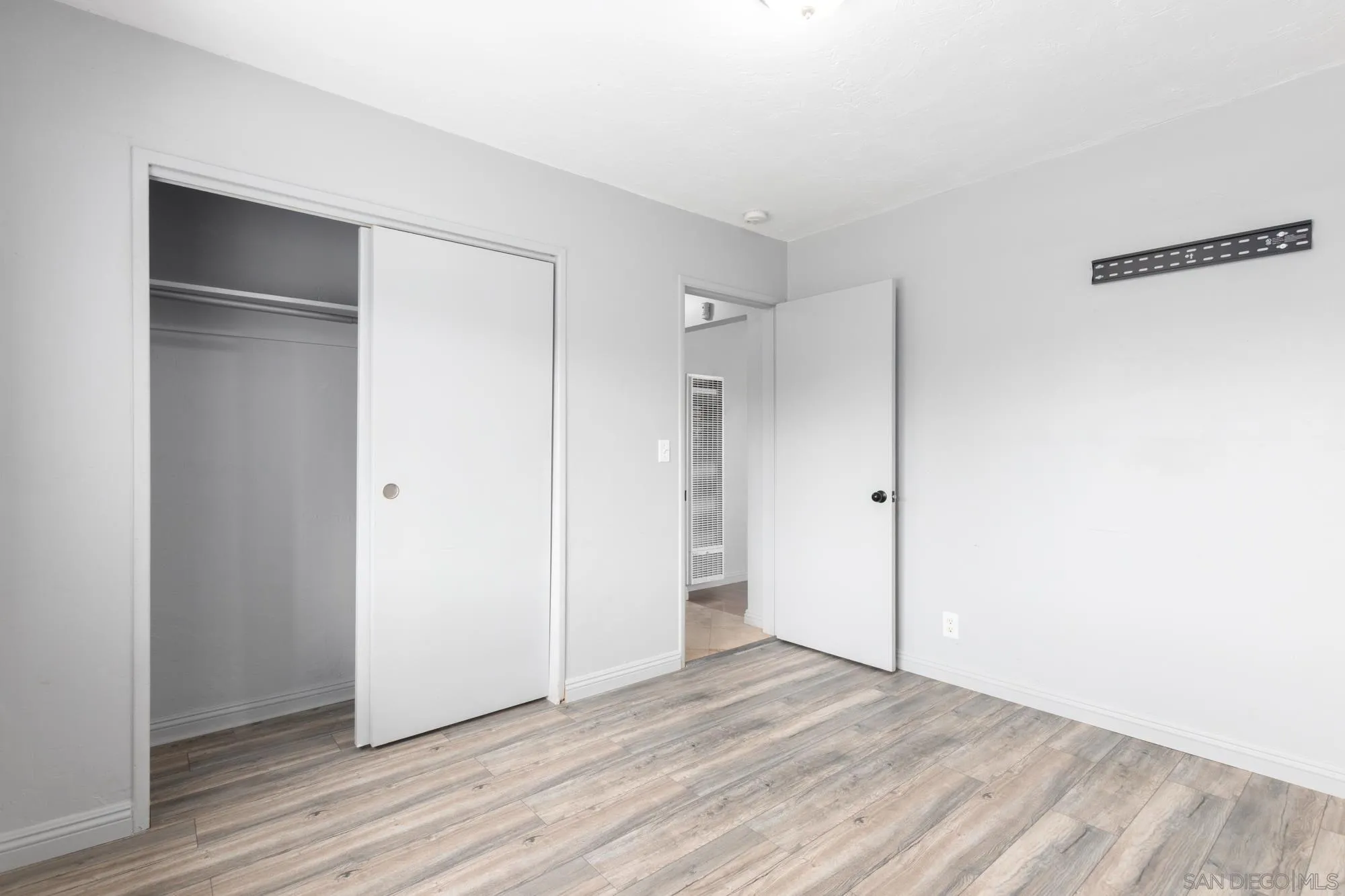 909 North Midway Drive Escondido, CA 92027 - Photo 13 of 19 a view of an empty room with wooden floor