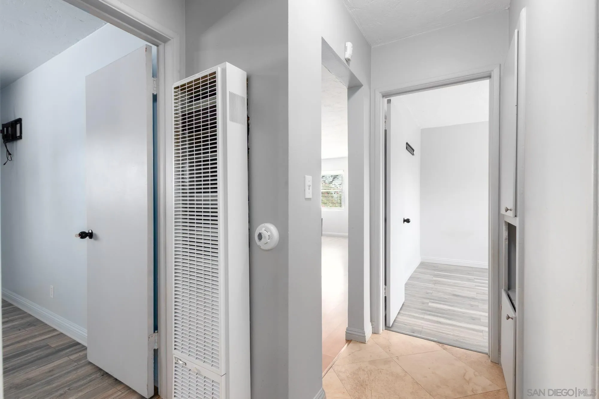 909 North Midway Drive Escondido, CA 92027 - Photo 14 of 19 a view of a hallway with wooden floor and staircase