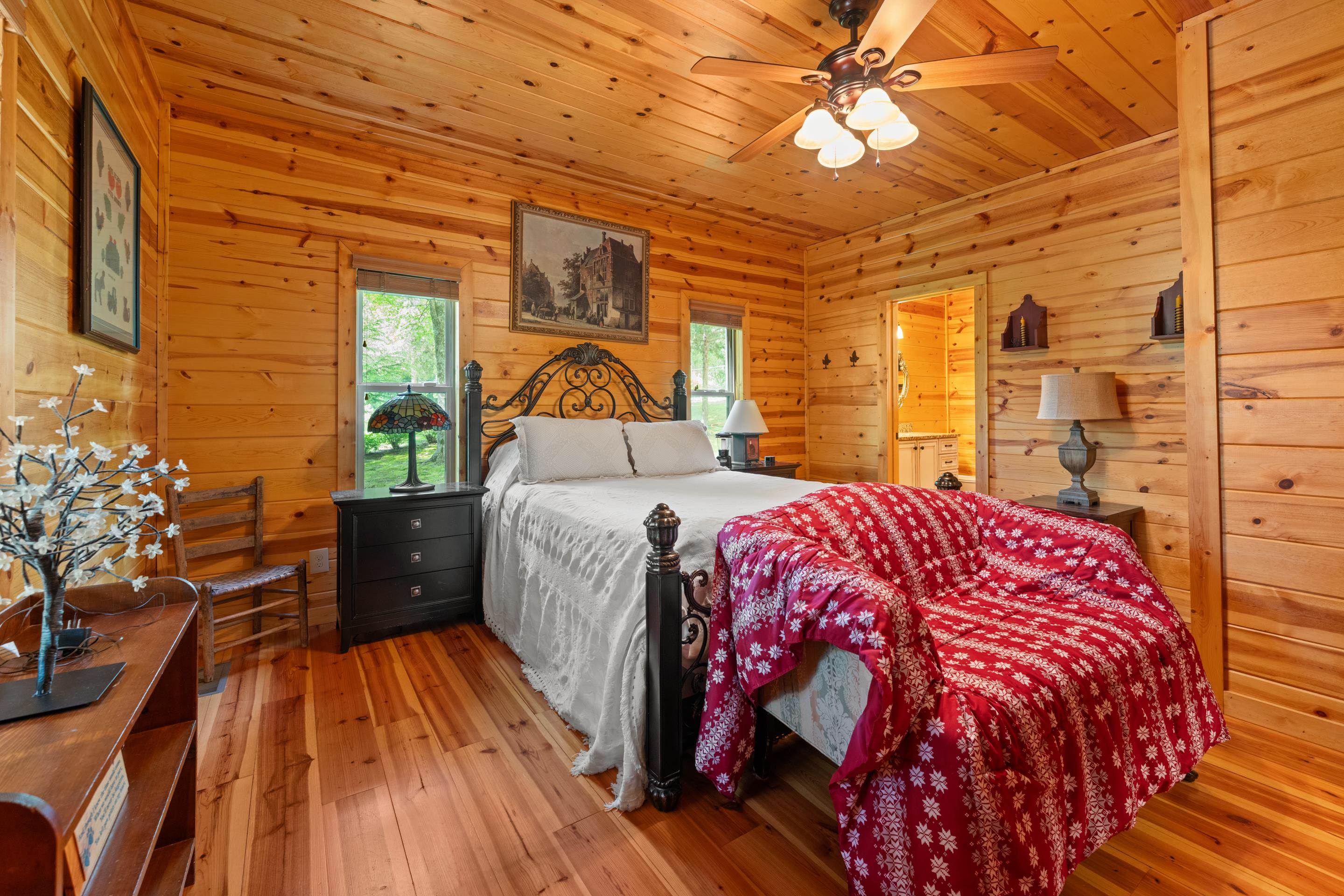 950 Cherry Road Eads, TN 38028 - Photo 11 of 30 Wood-paneled room featuring wood-finish flooring, a ceiling fan with integrated lighting, and multiple windows