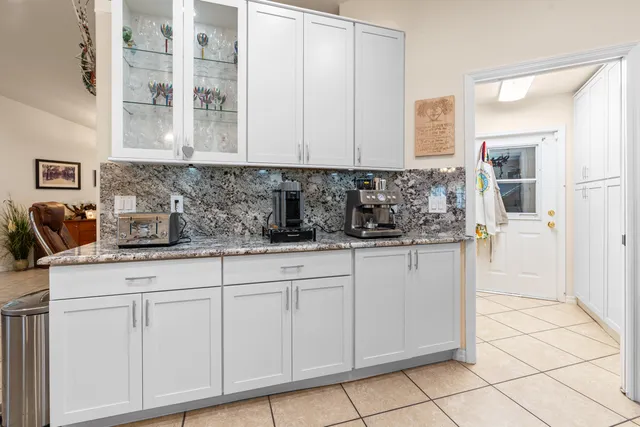 a kitchen with a sink appliances cabinets and furniture