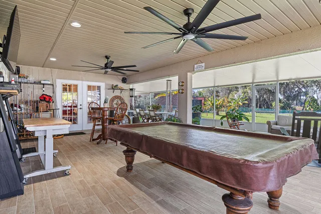 a view of a porch with chairs and potted plants