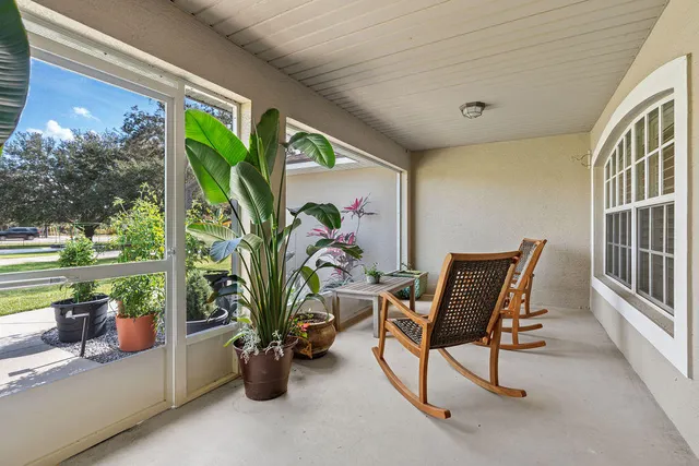 a view of a house with a yard porch and sitting area