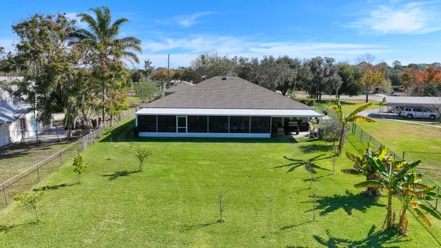 a view of a house with backyard porch and sitting area