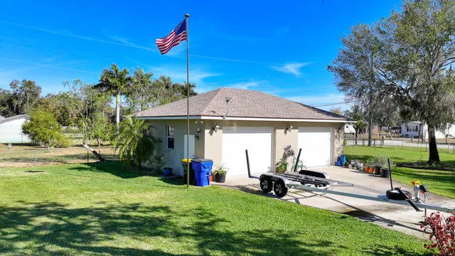 an aerial view of ocean and residential houses with outdoor space